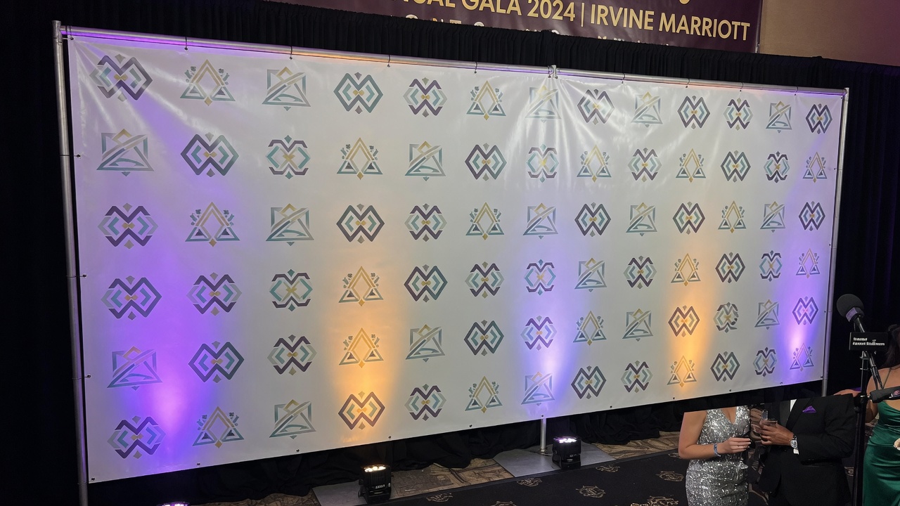 Step-and-repeat logo wall at an Irvine hotel event